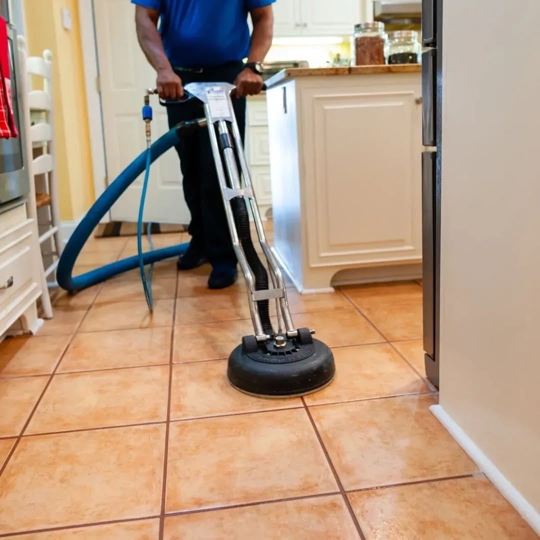 Rotary machine scrubbing kitchen tile floor