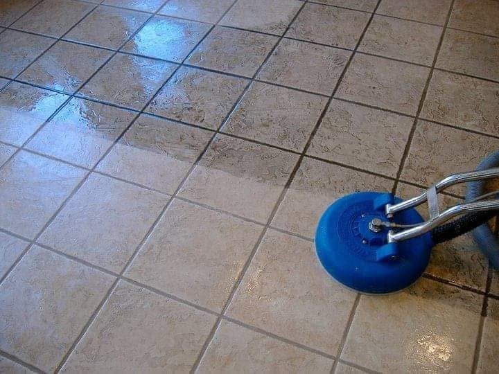 Close-up of rotary scrubber cleaning wet tile