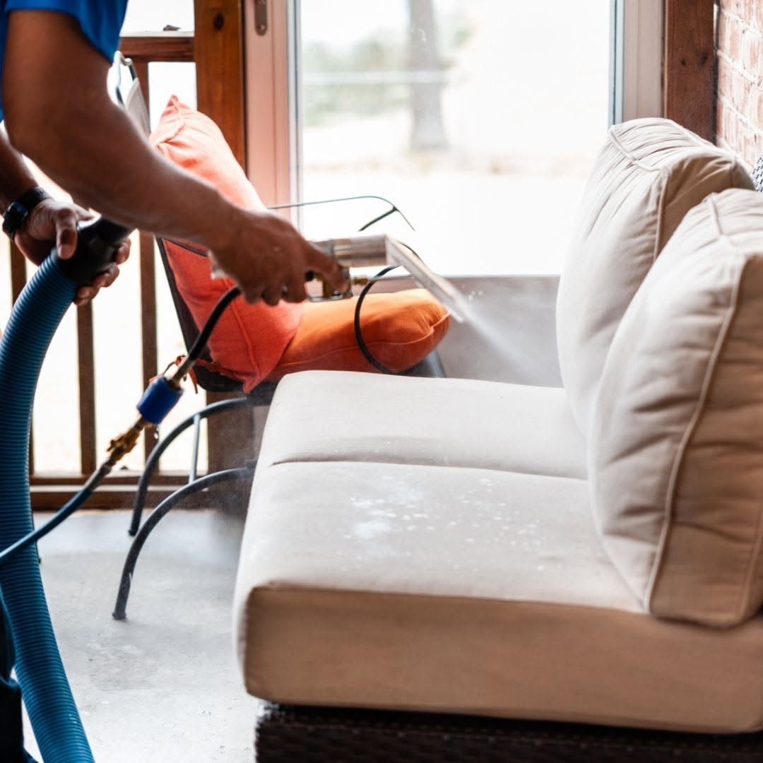 Close-up upholstery cleaning extraction on a light sofa cushion