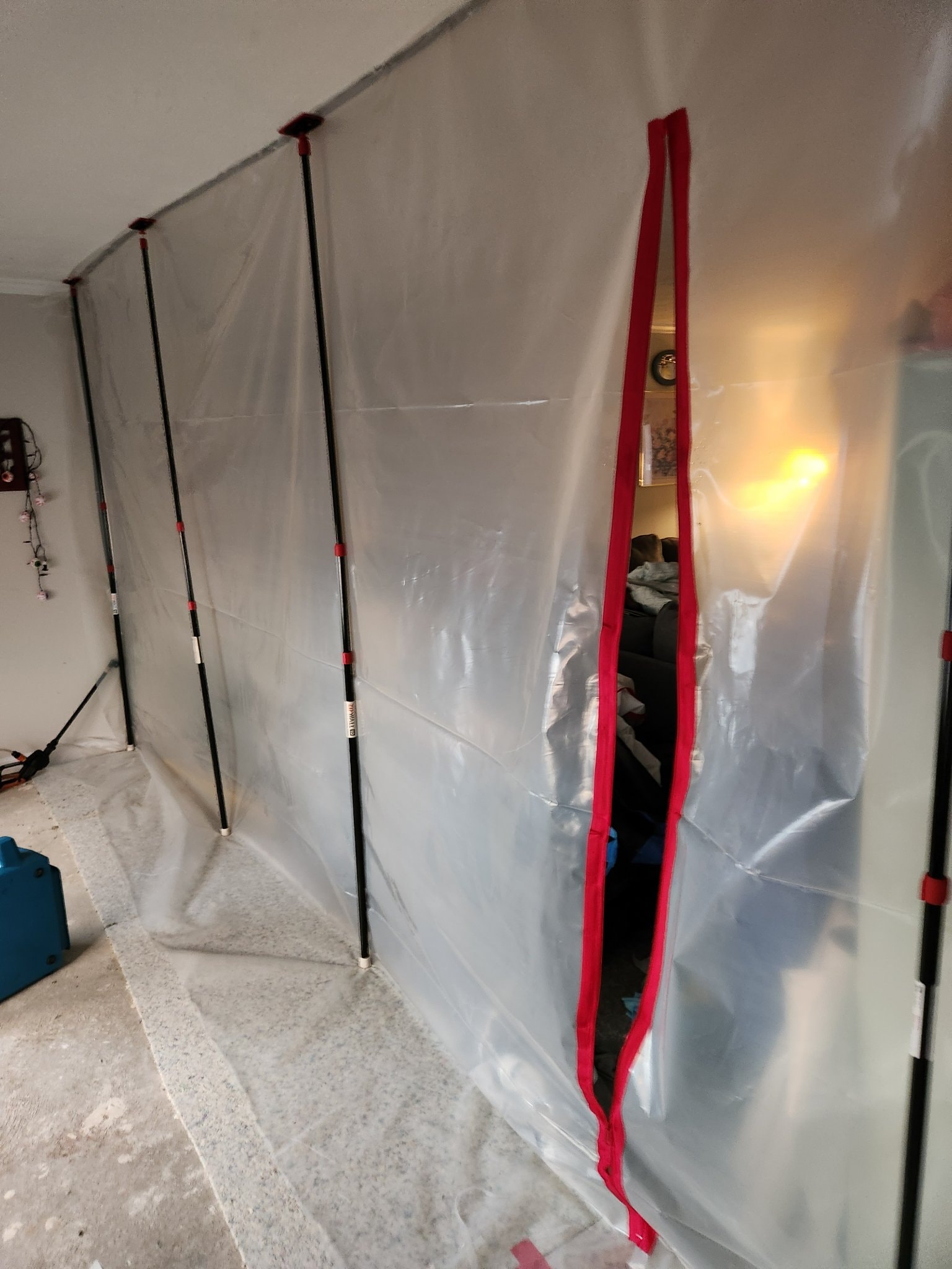Containment wall with zipper door during restoration