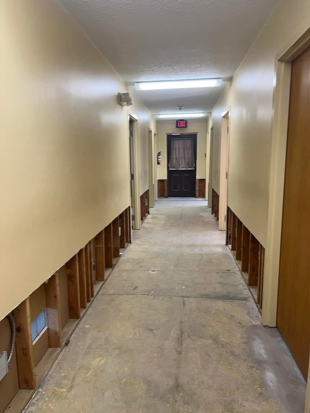 Commercial hallway flood cut during water damage demolition