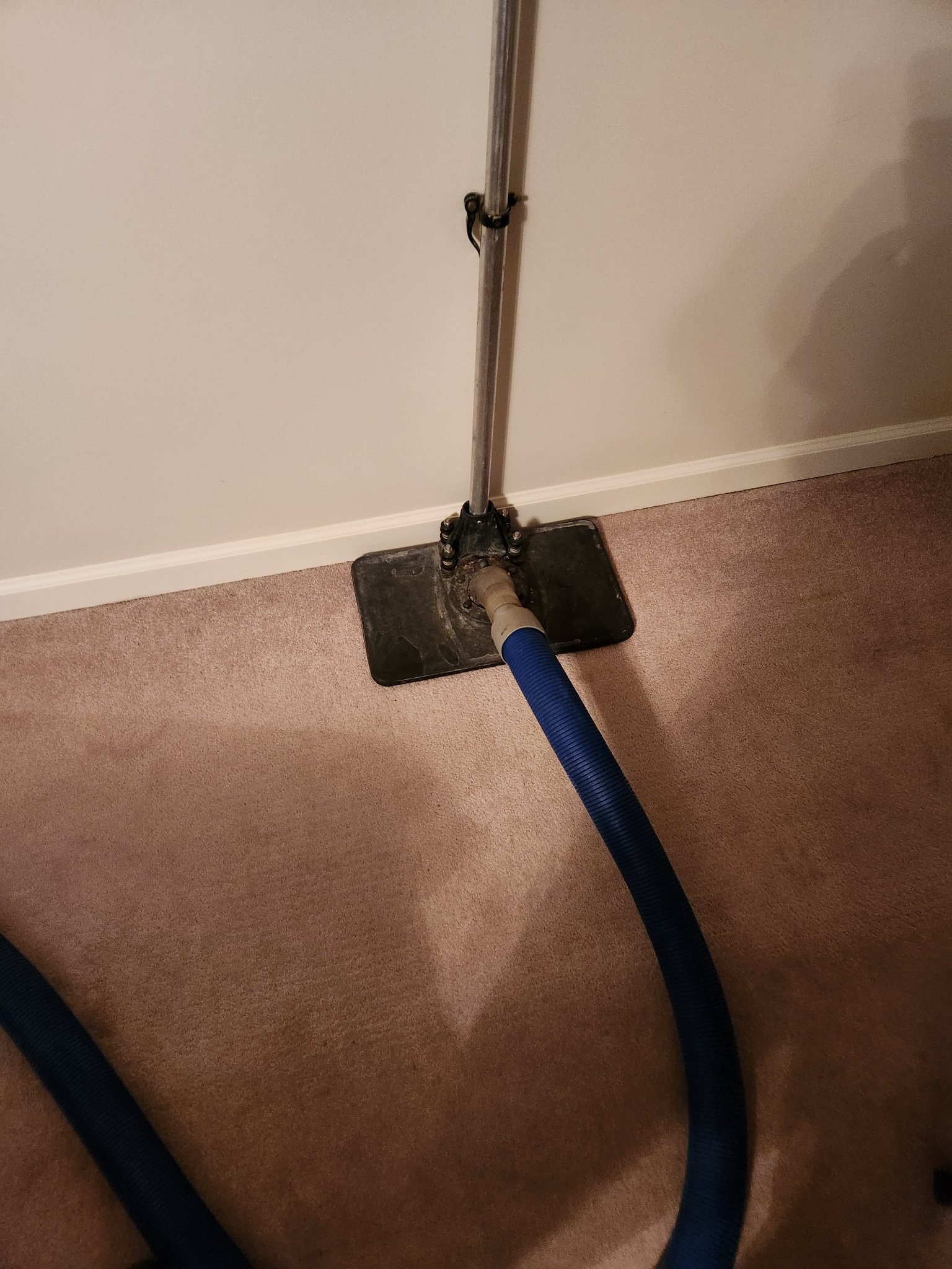 Weighted water extraction tool removing water from carpet